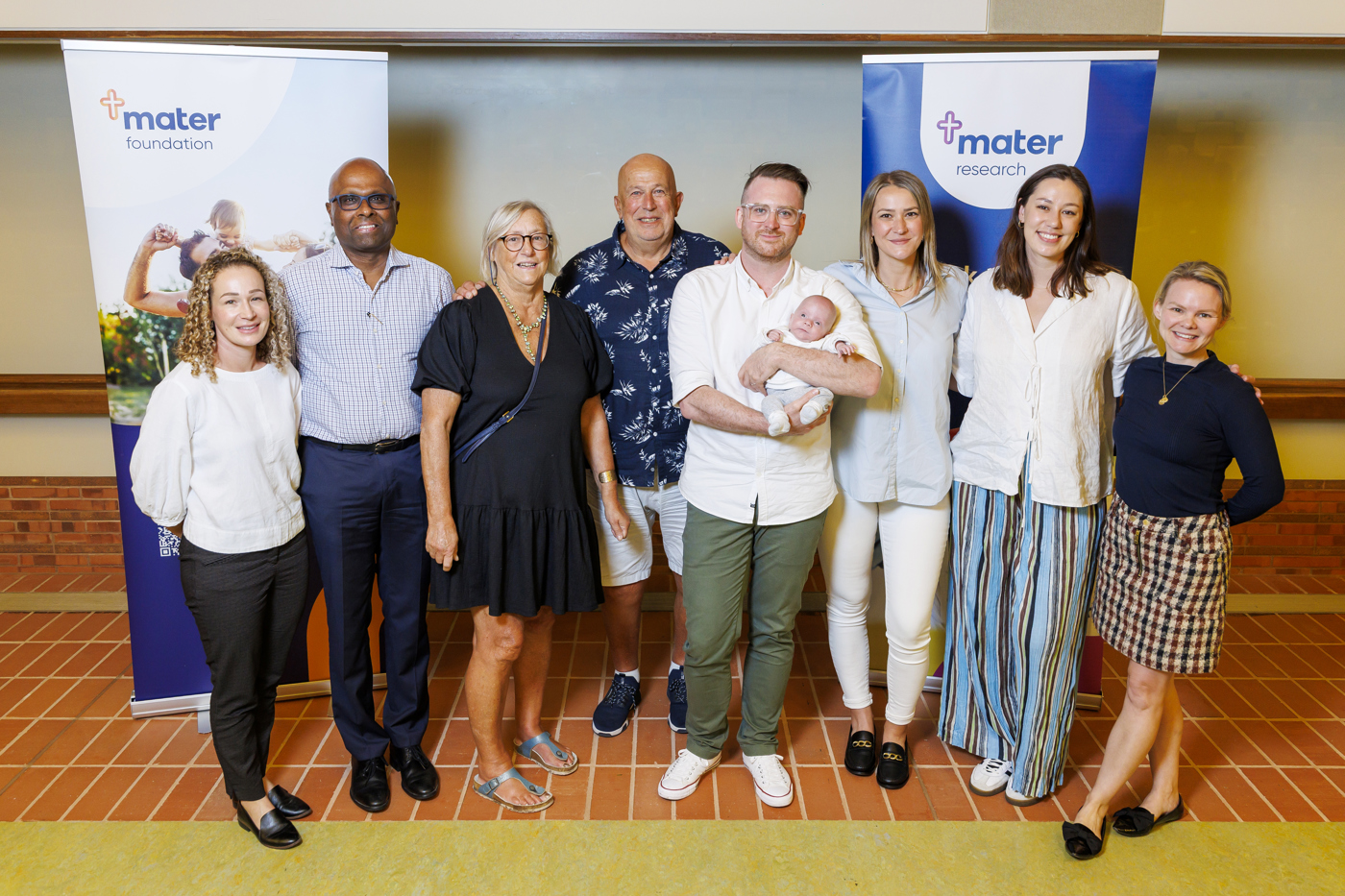 Professor Sailesh Kumar and members of Mater Mothers' Hospitals Fetal Growth Clinic with former patients Margaux, Chris and baby Oscar.